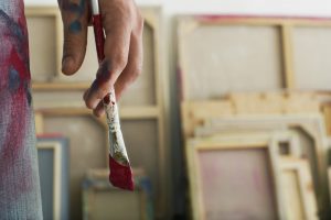 An artist holding a paintbrush
